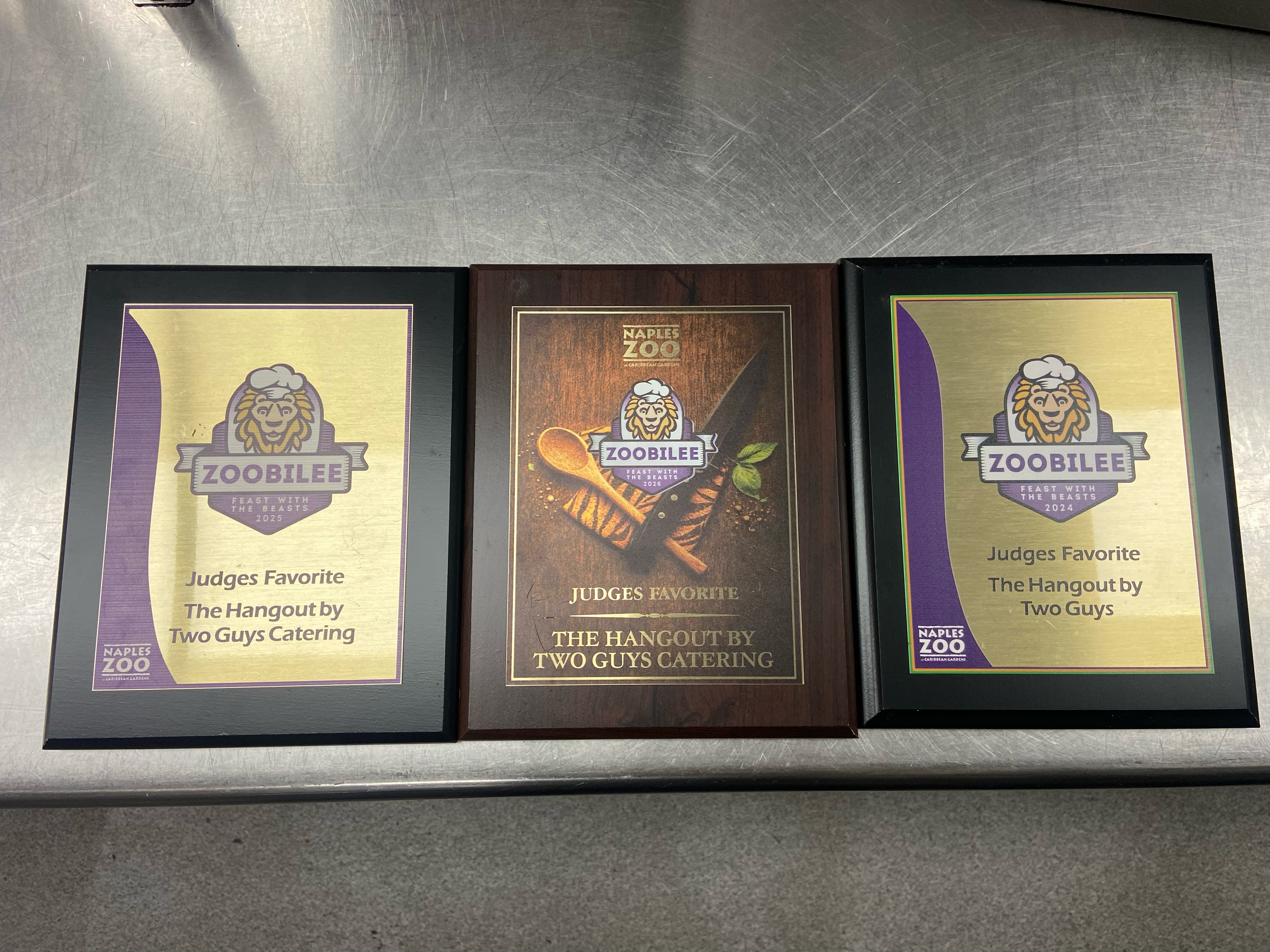 Three framed Judges’ Favorite awards from Naples Zoo’s ZOObilee: Feast With the Beasts, awarded to The Hangout by Two Guys Catering