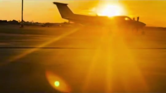 A private jet silhouetted at sunset at Elite Jets in Naples