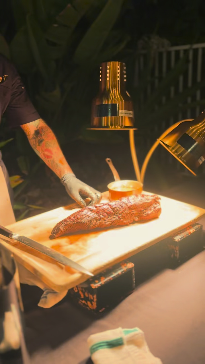 Filet mignon ready for carving under the warming lamps at the wedding