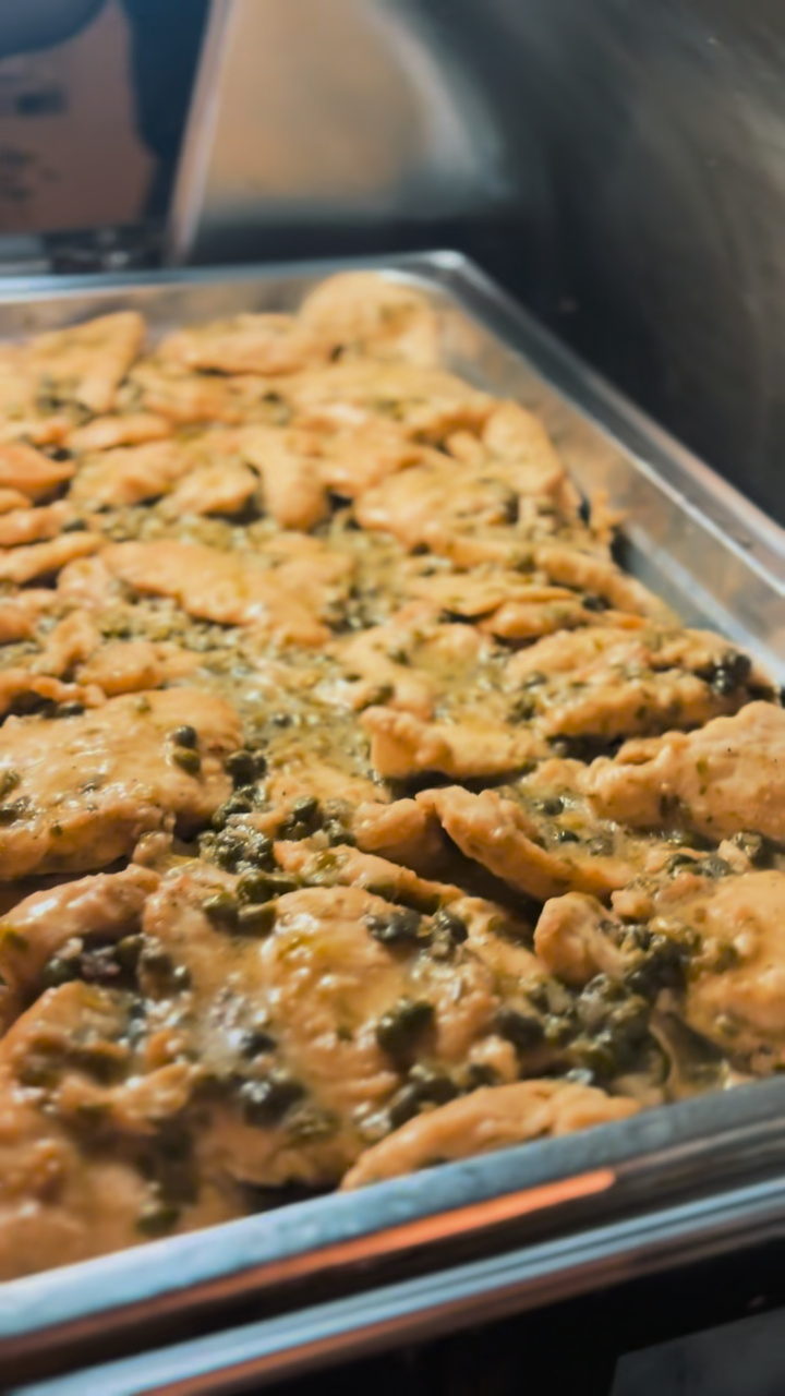 Chicken piccata prepared for the wedding dinner buffet