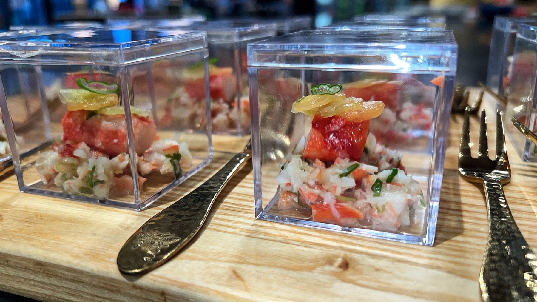 Individual seafood appetizers with citrus in clear presentation boxes