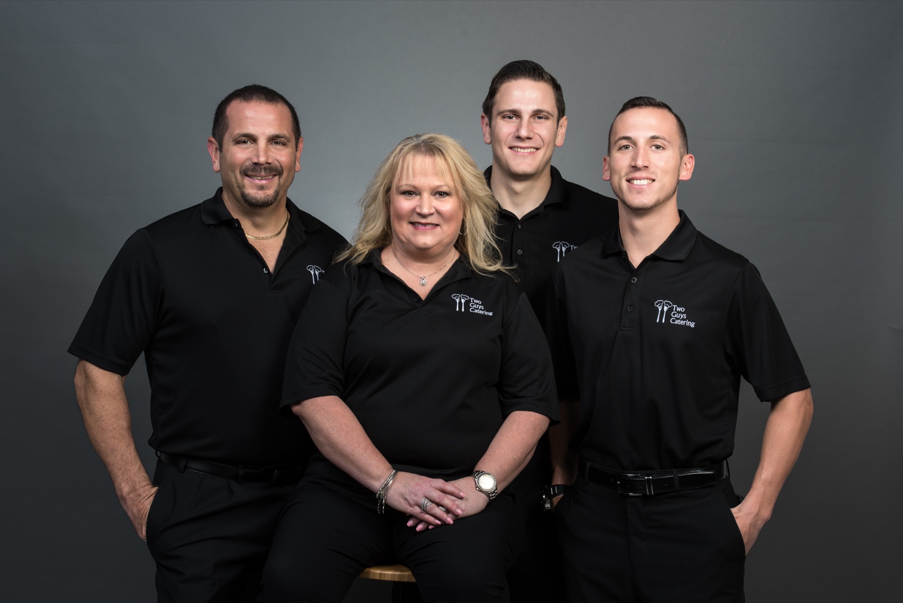The Falisi family together in Two Guys Catering shirts