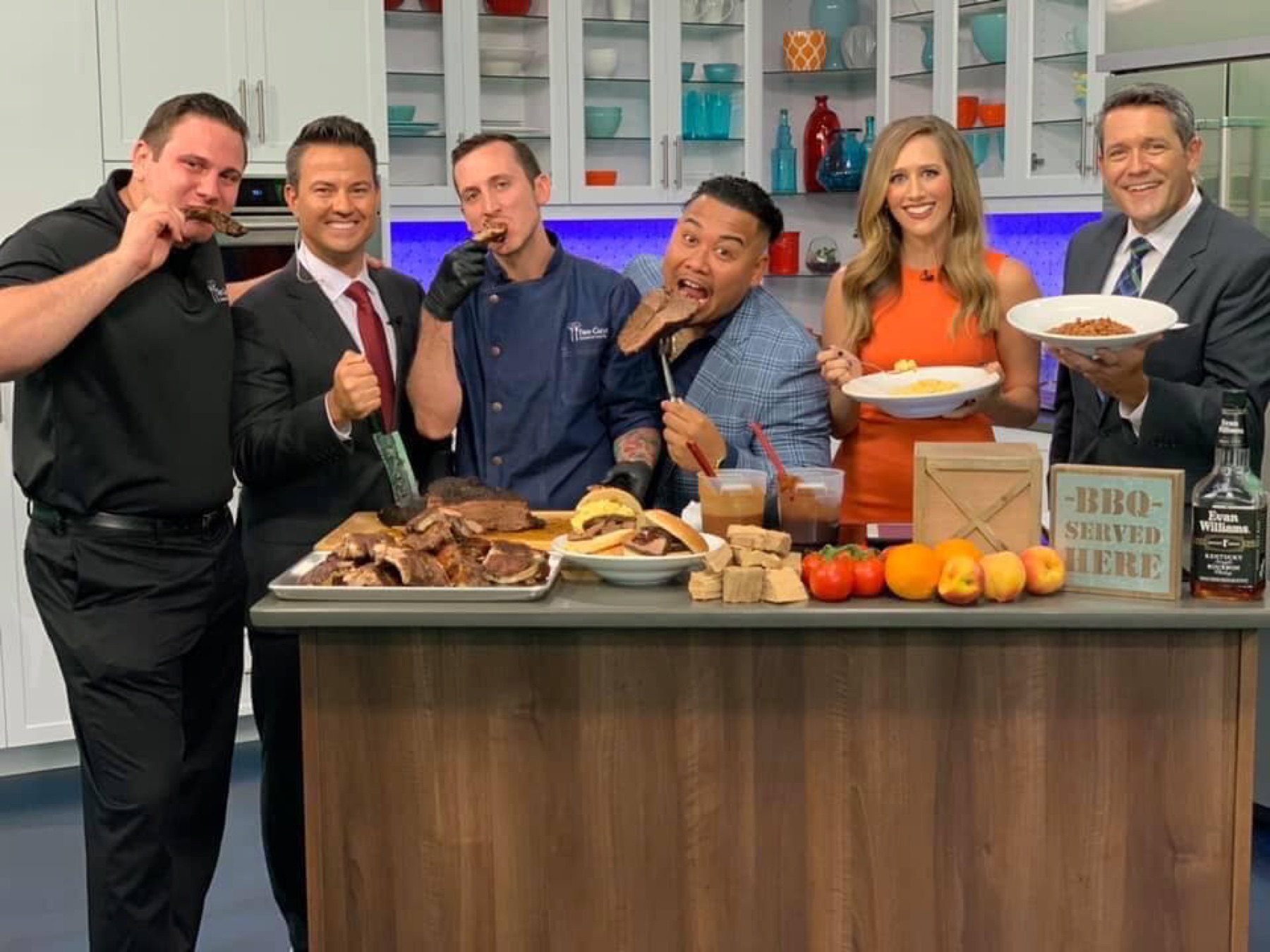 The Two Guys team sharing brisket and barbecue with television presenters in a studio kitchen
